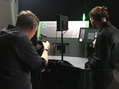 Two people filming a piece of technology as part of a marketing video for Opsydia