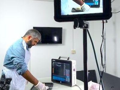 A man being filmed while demonstrating a MedTech product 